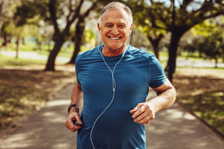 Older man on a run listening to music