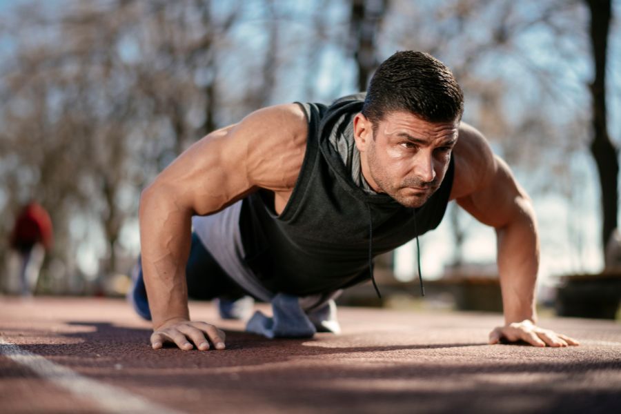 Man doing push-ups on a track