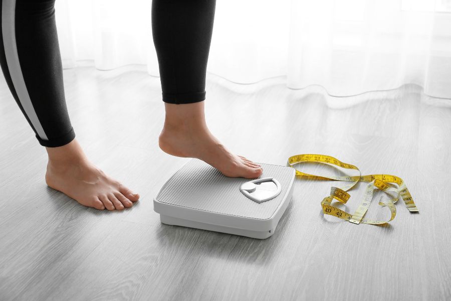 A women stepping onto a scale