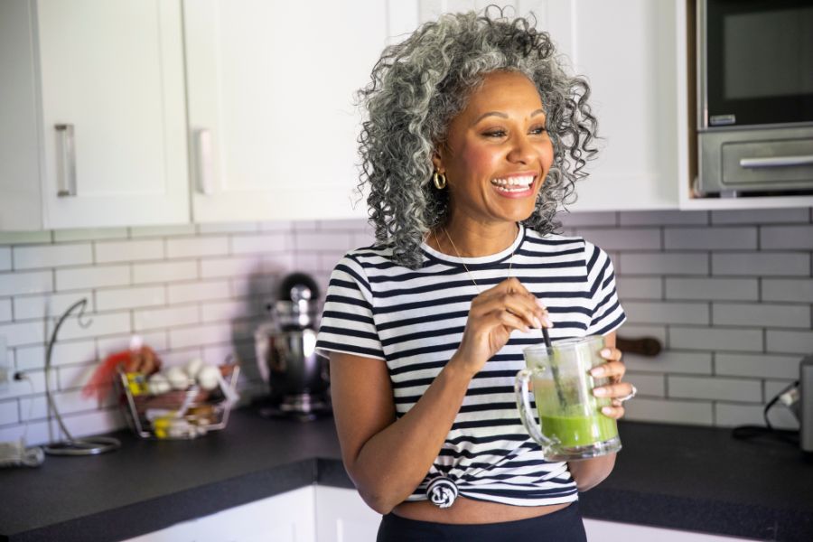 Woman laughing in her kitchen