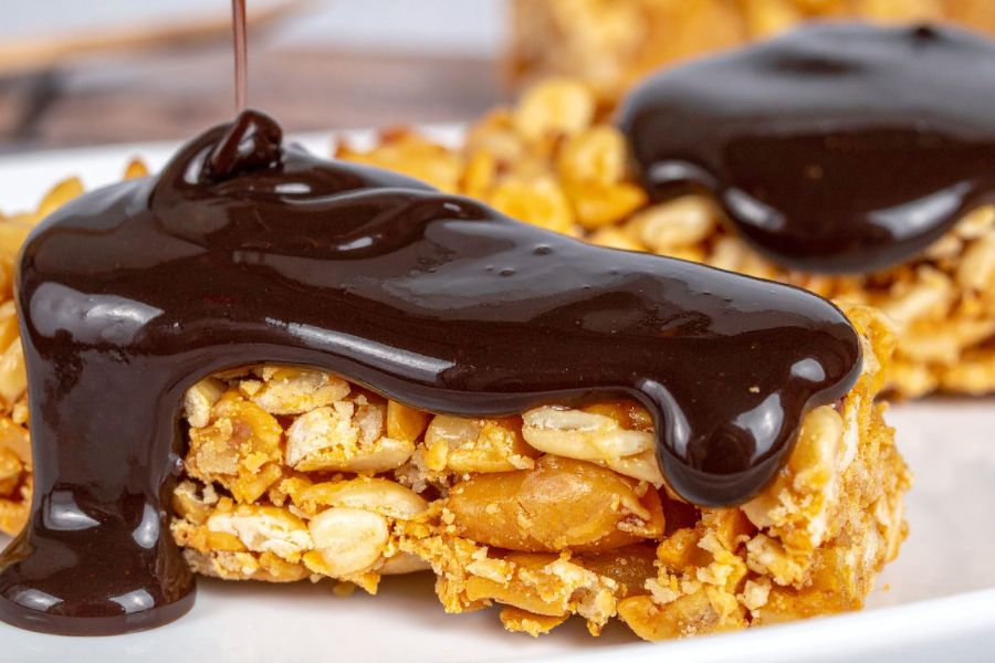 Protein bar showing gooey chocolate coating — looks like candy.