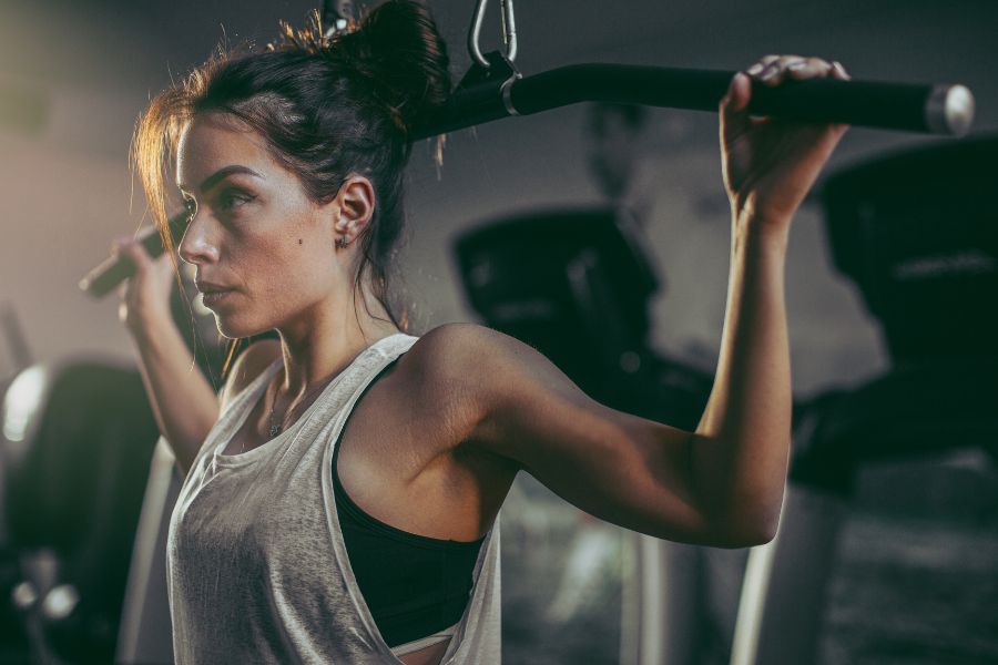 Woman lifting weights using a machine